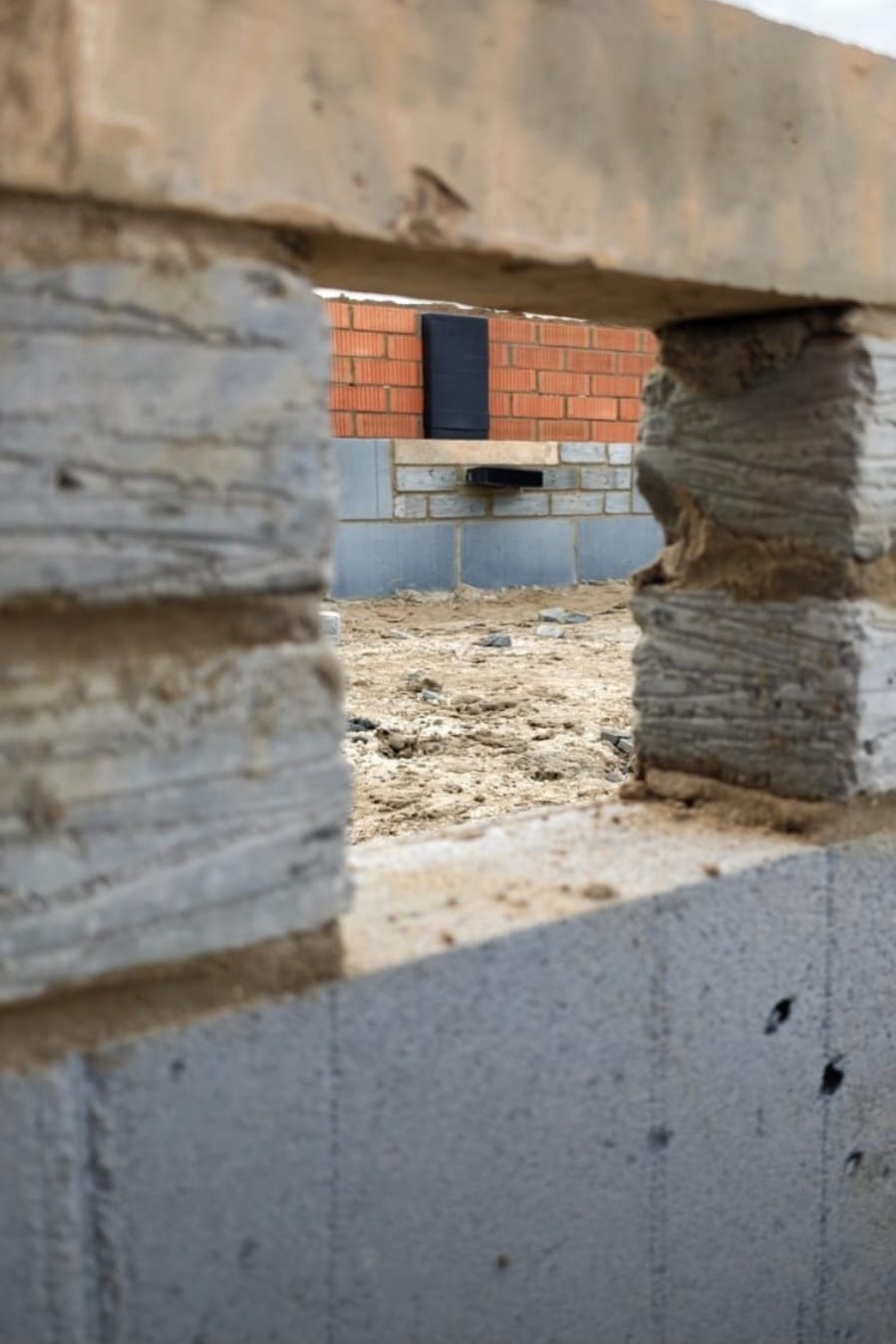 View through blockwork showing new build construction in progress