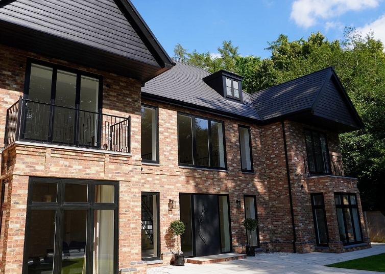 Completed luxury brick home with balconies and modern finish