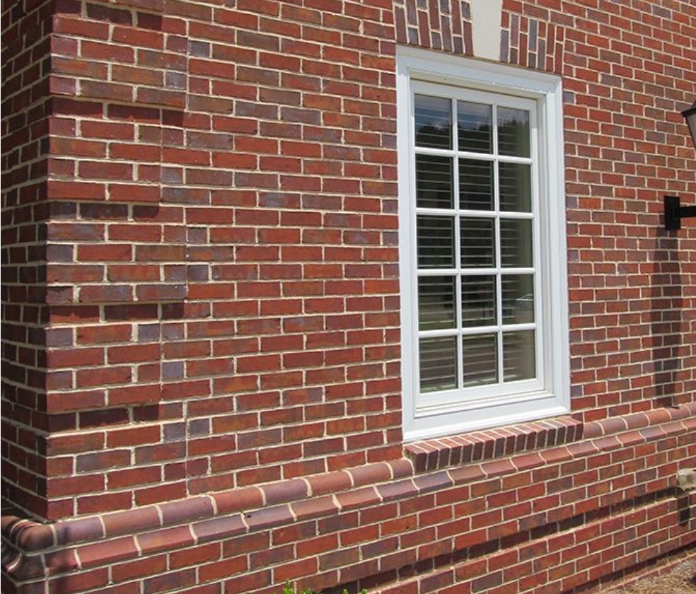 Red brick wall with window - decorative band course detail