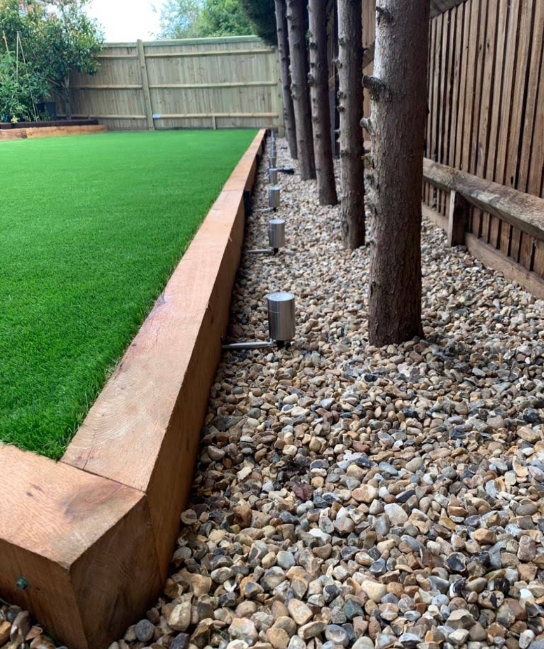 Landscaped garden with artificial grass and timber edging