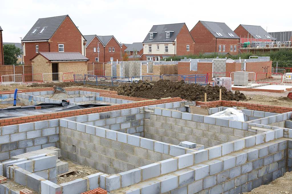 Housing development with blockwork foundations and completed homes