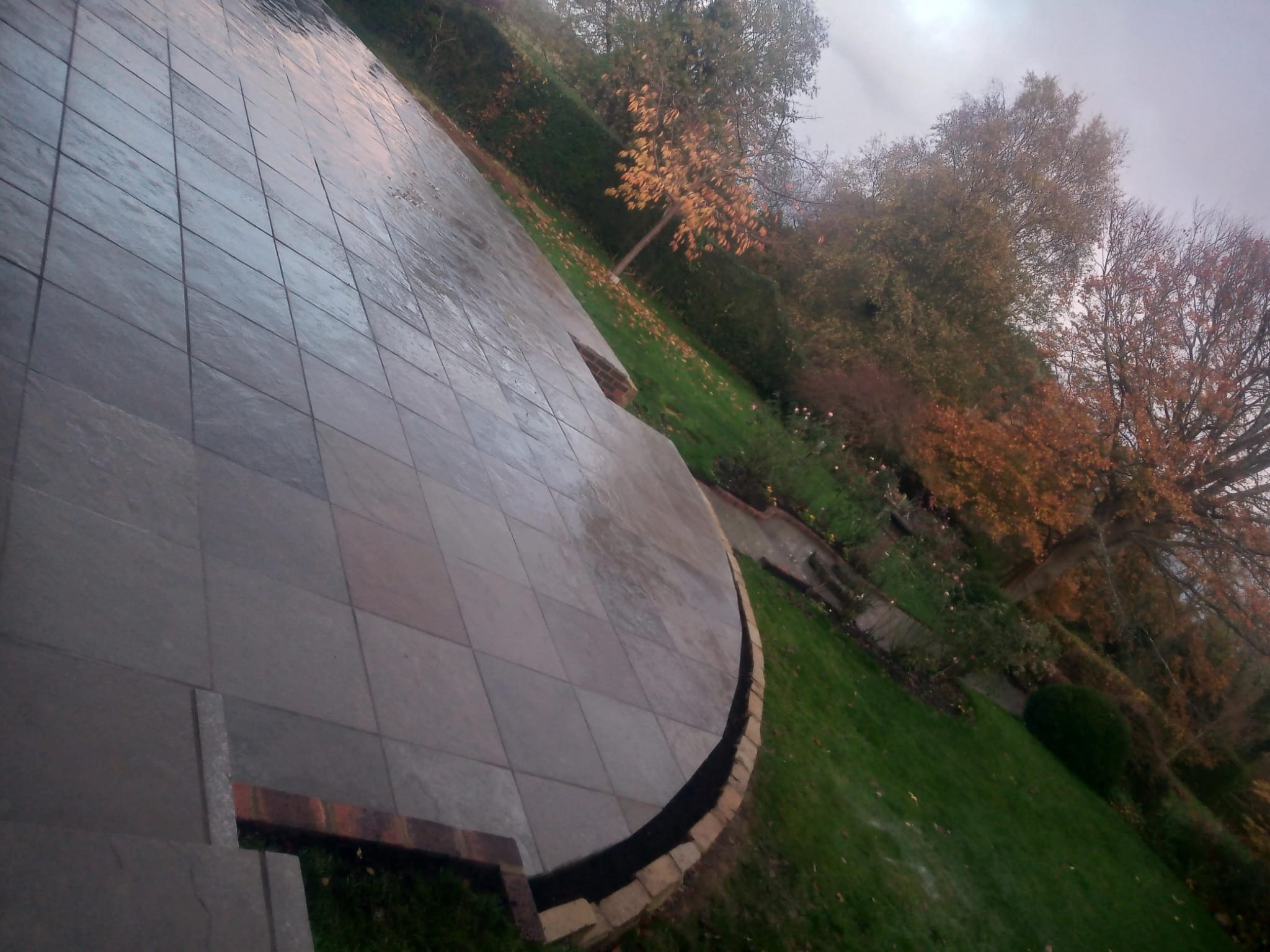 Curved raised patio with stone retaining wall - angled view