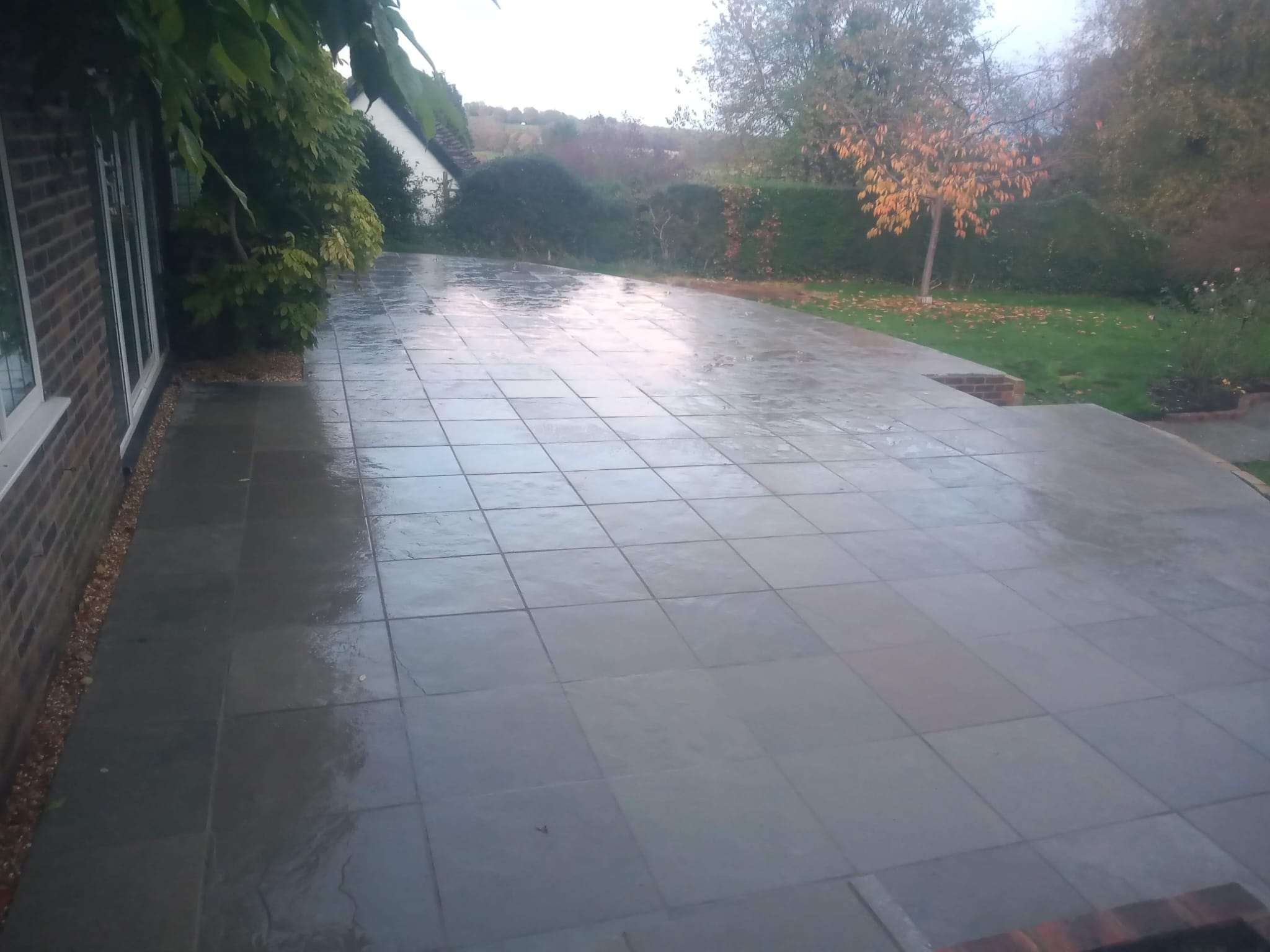 Expansive slate patio with autumn garden views