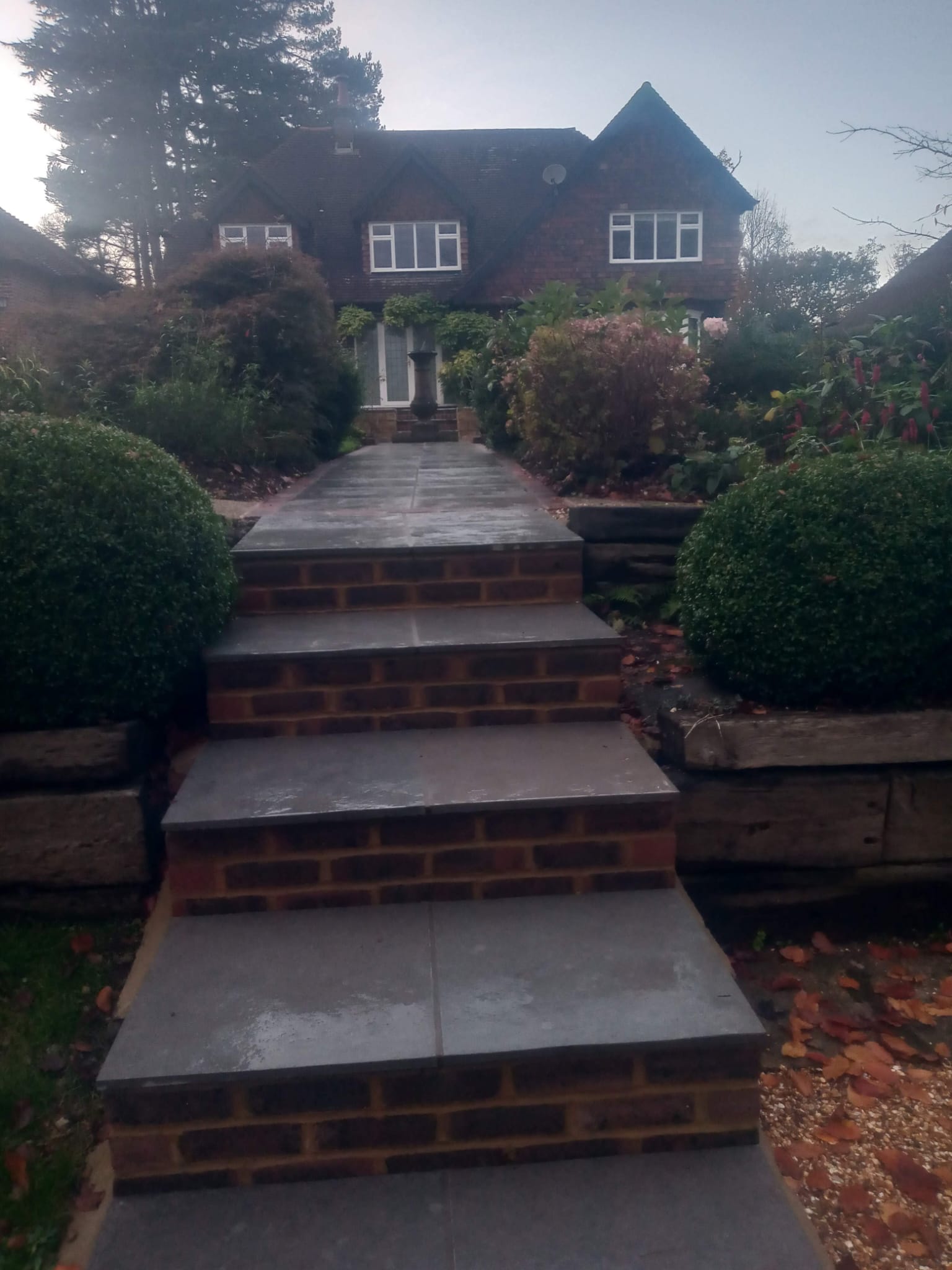 Elegant brick steps with slate treads leading to house entrance